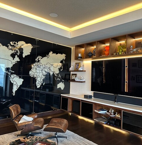 Media lounge with illuminated shelving, concealed audio and integrated television