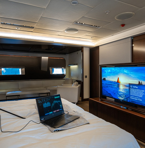 Guest cabin with integrated television, touchscreen control and concealed ceiling speakers
