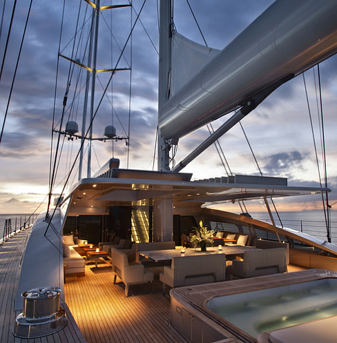 Illuminated superyacht deck at dusk with integrated lighting, audio and spa controls
