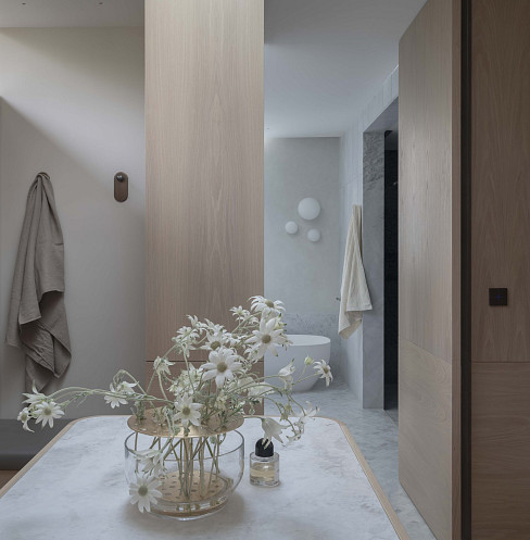 Minimal bathroom with concealed lighting and discreet wall-mounted smart controls