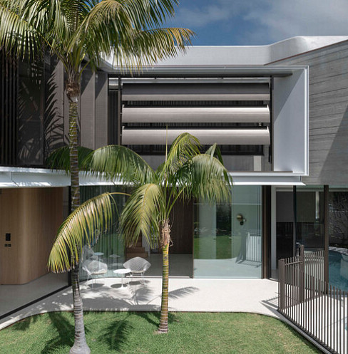 Modern home exterior with automated louvres providing solar shading above the courtyard