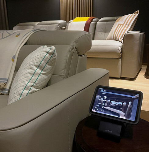 Tablet cinema controller positioned beside a reclining seat for simple system operation