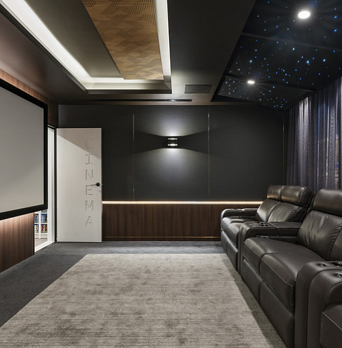 Sound-isolated home cinema with starlight ceiling, large screen and leather recliners