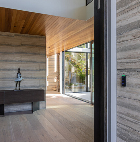 Secure entrance with keyless access control mounted beside the timber-lined doorway