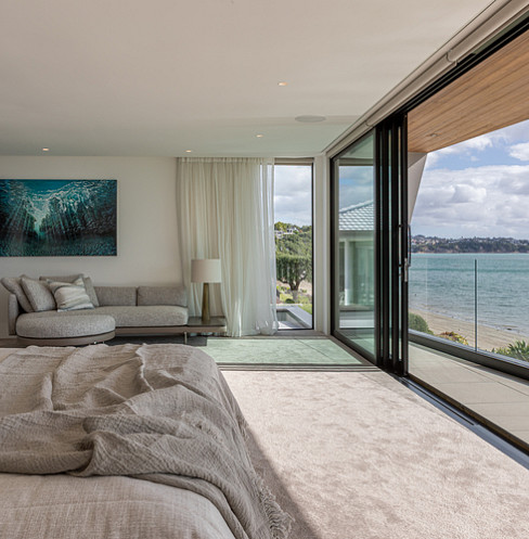 Waterfront bedroom with automated glazing, concealed speakers and whole-home climate control