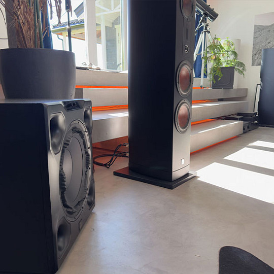 DALI SUB V-16 F subwoofer positioned beside an EPICON 8 speaker in a modern listening room