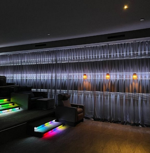 Home cinema entrance with illuminated steps, control keypad and acoustic finishes
