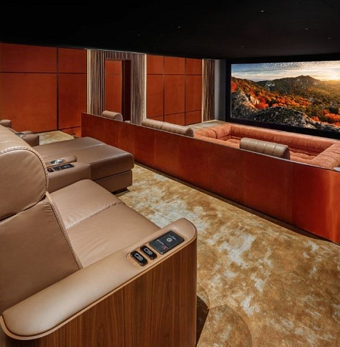 Luxury home cinema with tiered recliners and central sunken lounge seating