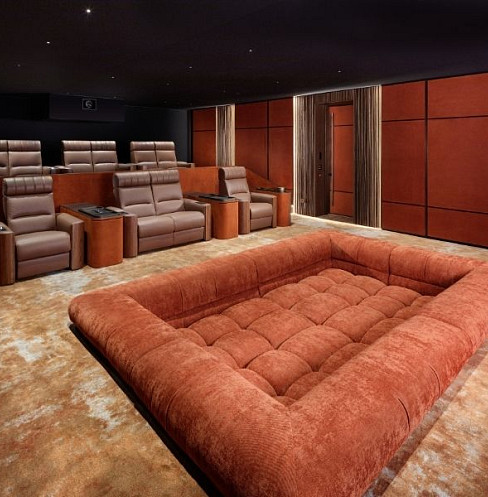 Tiered leather cinema seating with integrated controls and acoustic wall treatment