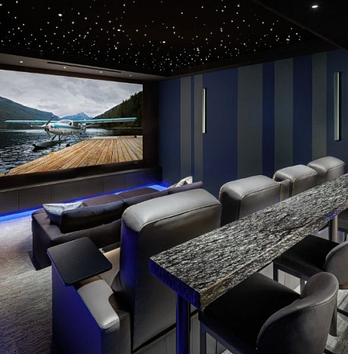 Luxury home cinema with star ceiling, large screen and bar-height rear seating