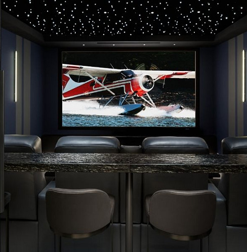 Rear view of the home cinema with lounge seating, leather recliners and star ceiling