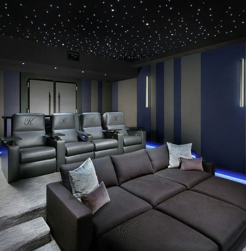 Tiered home cinema seating with star ceiling and blue LED floor lighting