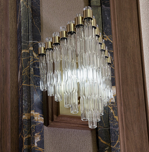 Decorative glass wall light integrated into the luxury home cinema interior