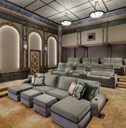 Luxury home cinema seating facing a concealed projection screen wall