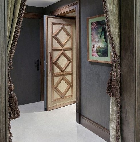 Sound-isolated cinema entrance with bespoke timber door and acoustic seals