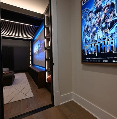 Entrance to a compact family media room with concealed acoustic treatment