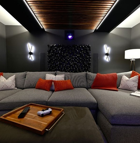 Family media room with projection, hidden speakers and relaxed lounge seating