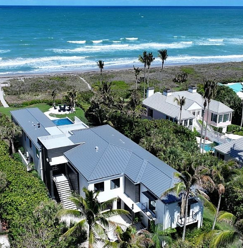 aerial view of modern smart home by the beach