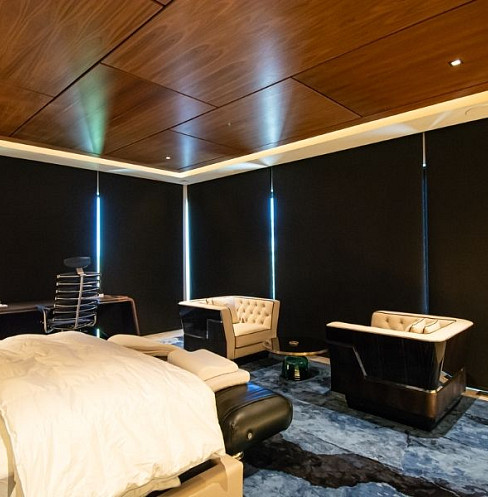 Bedroom sitting area with automated blackout shades and integrated entertainment