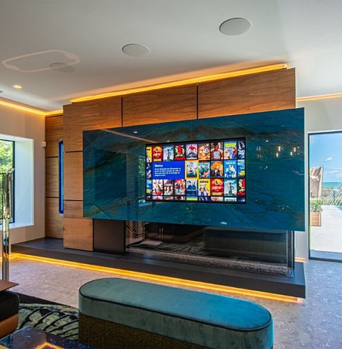 Living room with integrated television, architectural lighting and distributed audio