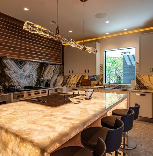 Luxury kitchen with layered smart lighting and discreet audio speakers
