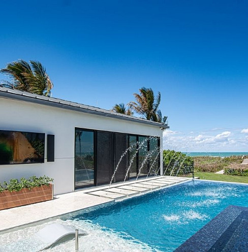 Modern smart home exterior and pool with automated lighting and surveillance