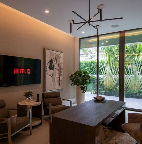Home office with integrated television, lighting and automated shading