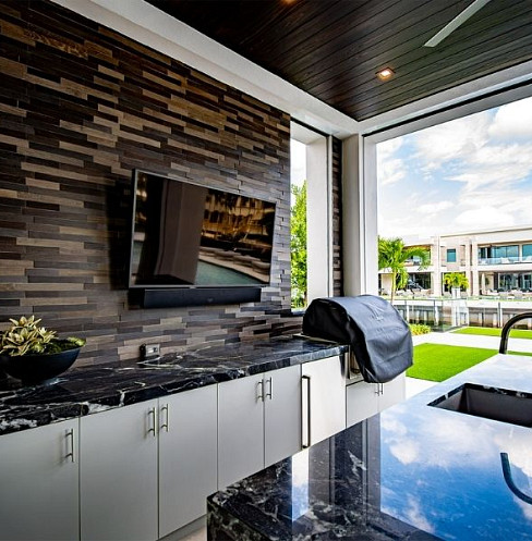 Outdoor kitchen with integrated display, audio and poolside controls