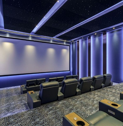 Large home cinema with tiered seating, Dolby Atmos and starlight ceiling