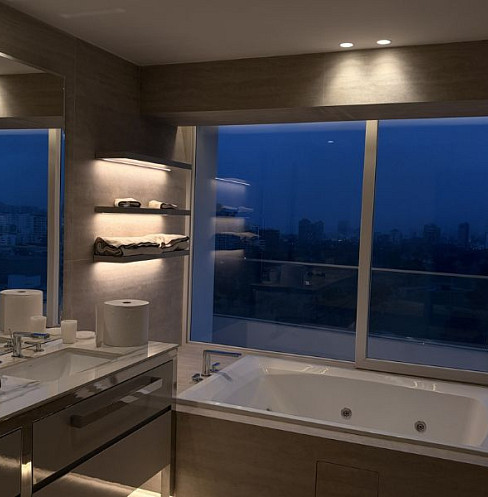 Luxury bathroom with automated lighting and city views