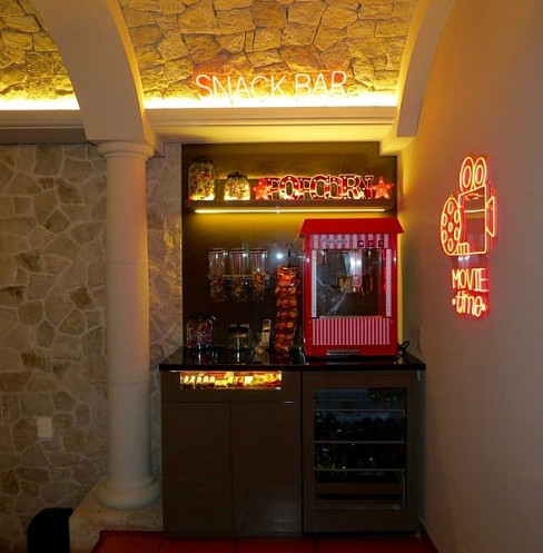Cinema snack bar with integrated lighting beside the theatre entrance