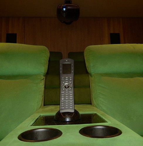 ELAN cinema control placed between reclining home theatre seats