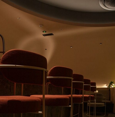 Cocktail bar with hidden subwoofers built into seating banquettes