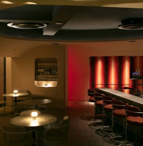 Commercial audio speakers mounted discreetly above bar seating