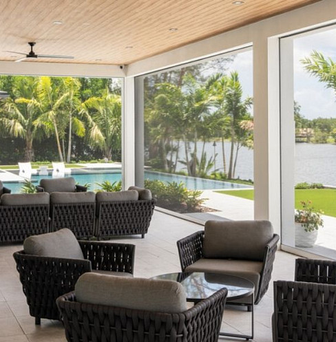 Glass-walled smart home exterior with architectural lighting