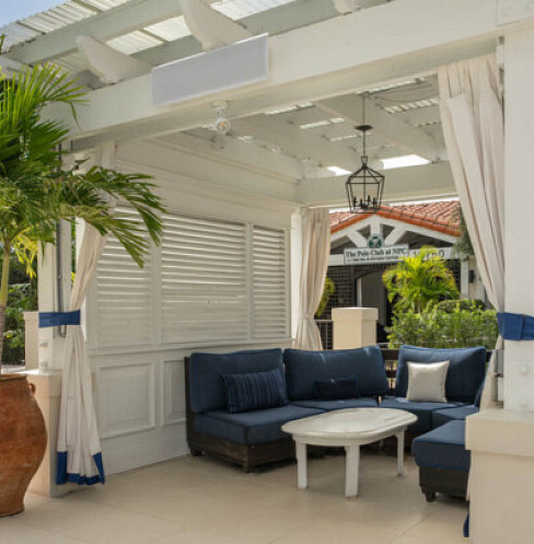 Covered patio lounge with discreet outdoor speakers and unified Control4 operation