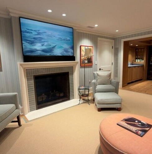 Fireplace television and accessible smart controls in a comfortable lounge