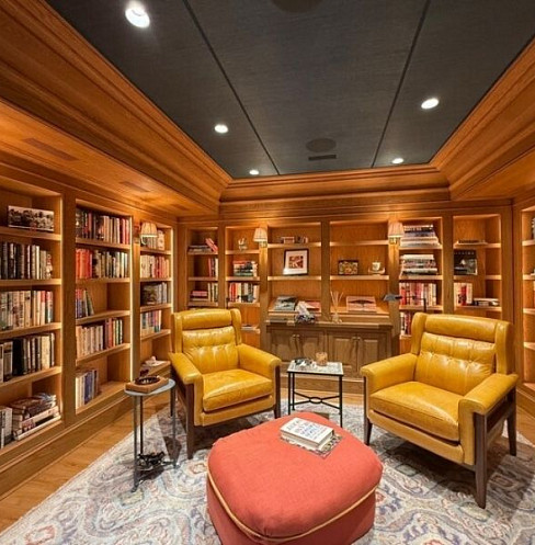 Wood-panelled library with fixed smart controls and integrated audio