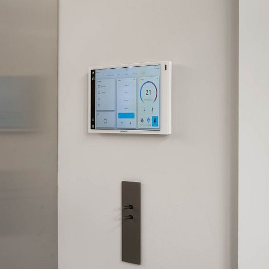 Wall-mounted touchscreen controlling a smart home system
