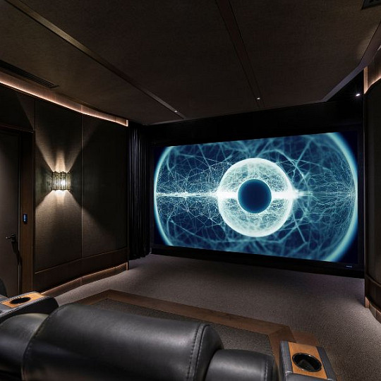 Dedicated home cinema with leather seating and a large projection screen